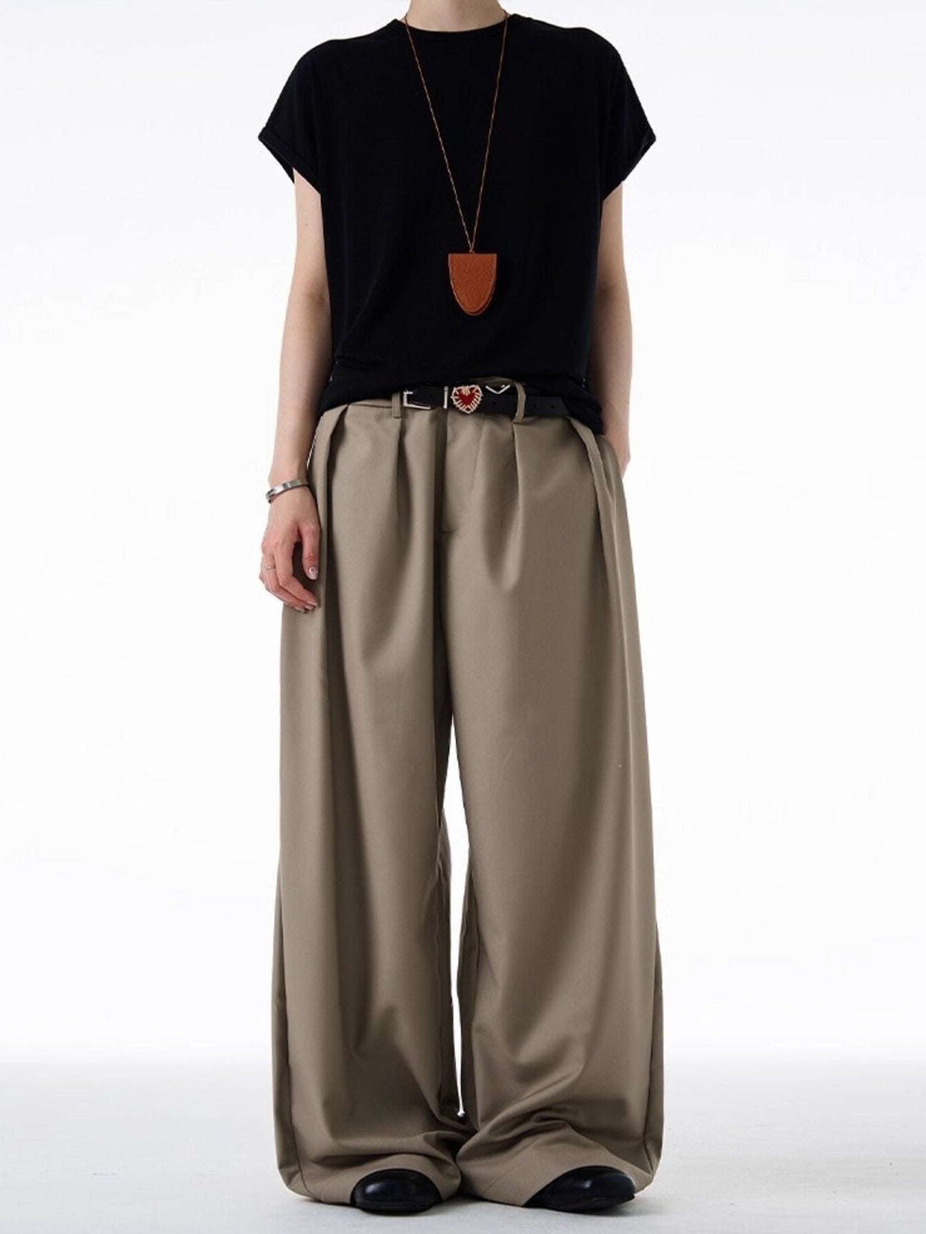 Khaki relaxed fit trousers with pleats and an elastic waistband.