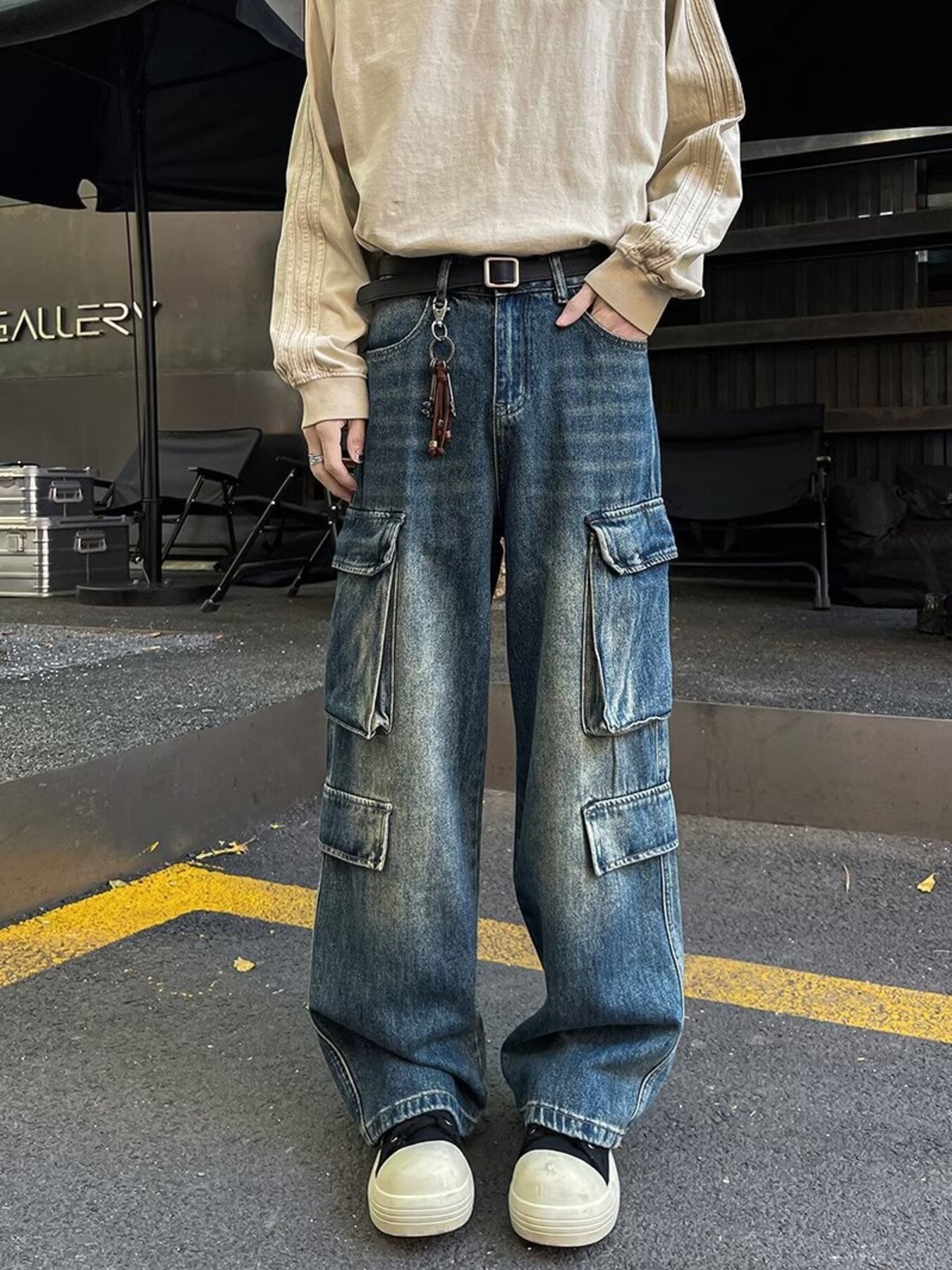 Men's vintage wash blue denim wide-leg cargo pants with multiple pockets.