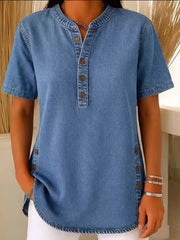 Denim-inspired blue short sleeve button-down blouse with mandarin collar and side button detail.