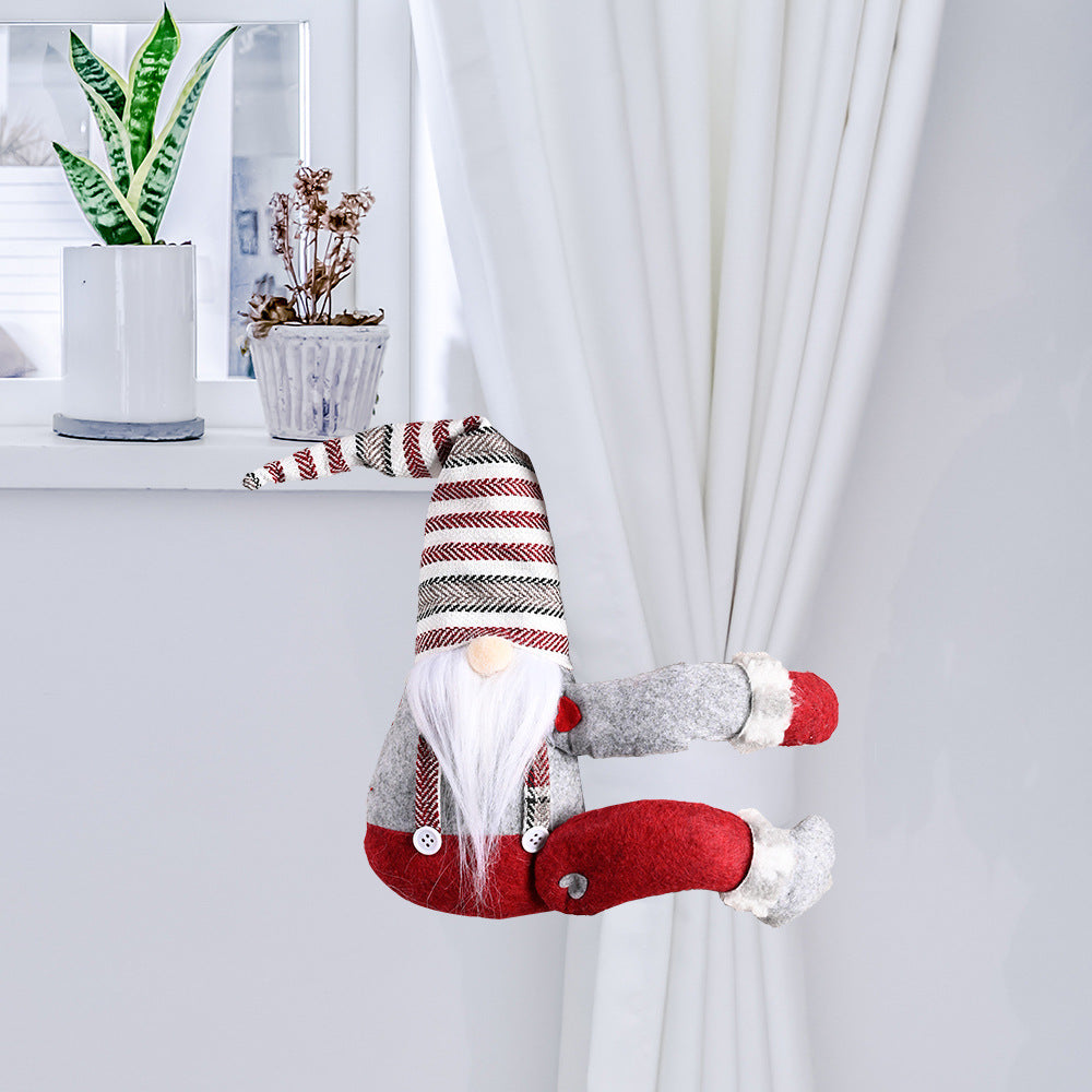 Charming gnome curtain tie-back in red and gray with striped hat, holding white curtains.