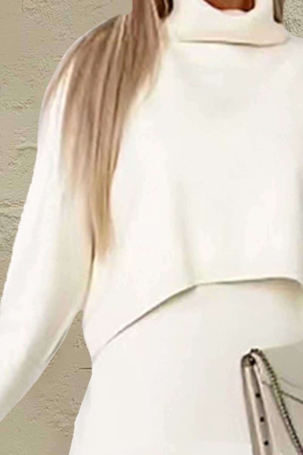 Ivory knit turtleneck top with long sleeves and layered hem detail
