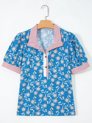 Blue cotton blouse with floral print, puff sleeves, and red striped collar and cuffs.