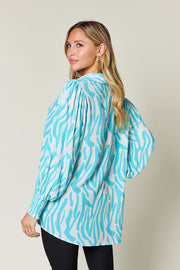 Tiffany Blue zebra print blouse with shirred cuffs and puff sleeves.
