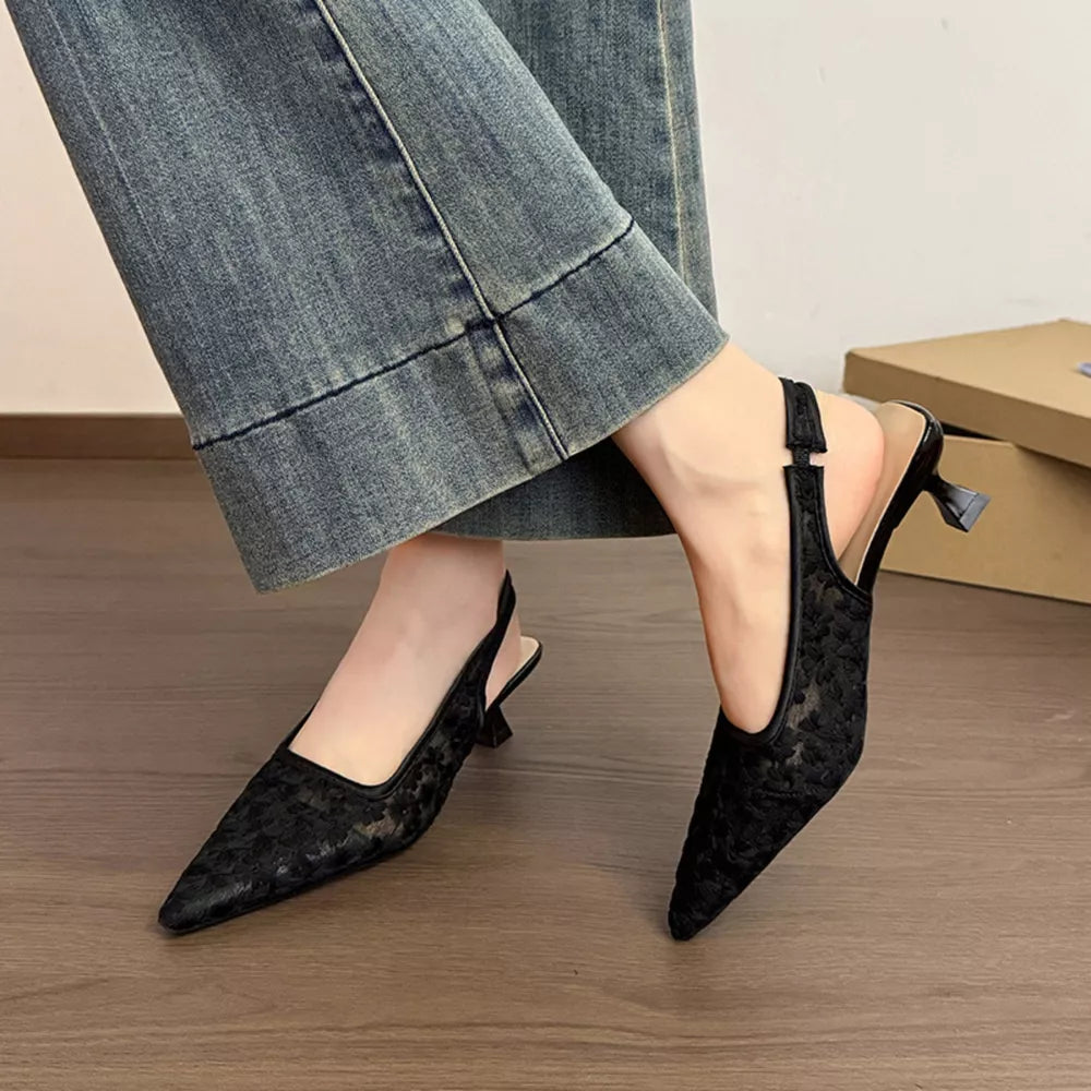 Black lace slingback kitten heels with pointed toe and adjustable ankle strap.