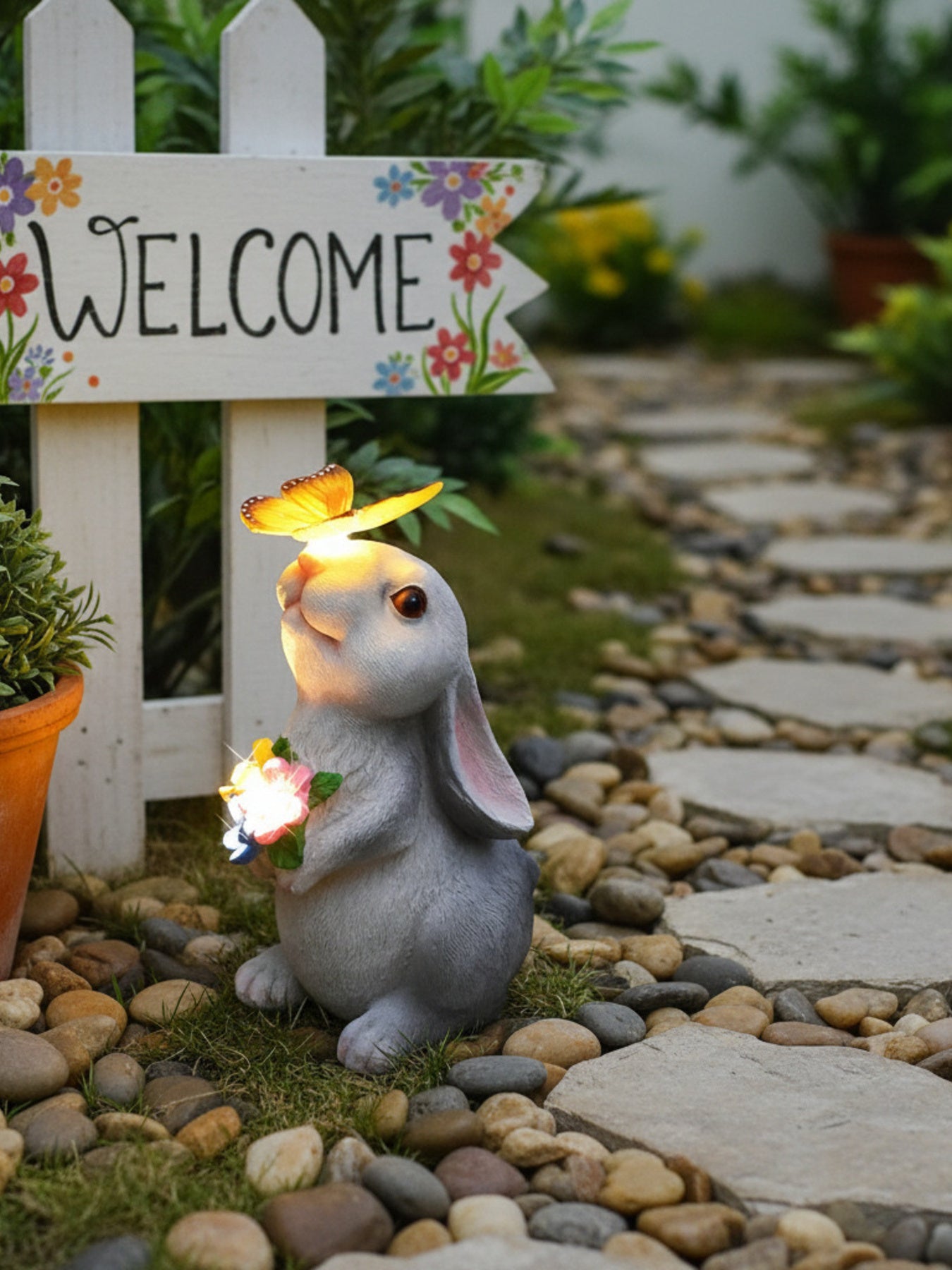 Easter bunny garden ornament with solar butterfly and light-up flowers.