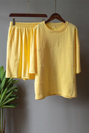 Banana yellow loungewear set with relaxed fit sweatshirt and shorts, featuring seam details.