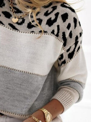 Leopard panel knit sweater in gray, white, and black with a crew neck and long sleeves.