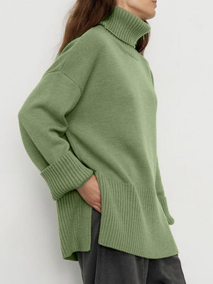 Matcha green ribbed turtleneck sweater with flared sleeves and cuffed hem.