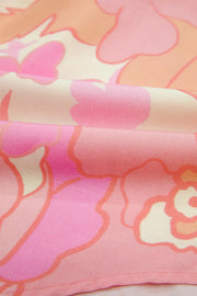 Short sleeve cotton shirt with a retro floral pattern in pink and orange hues.