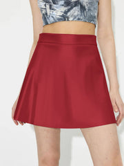 Crimson A-line mini skirt with a smooth finish, styled with a crop top.