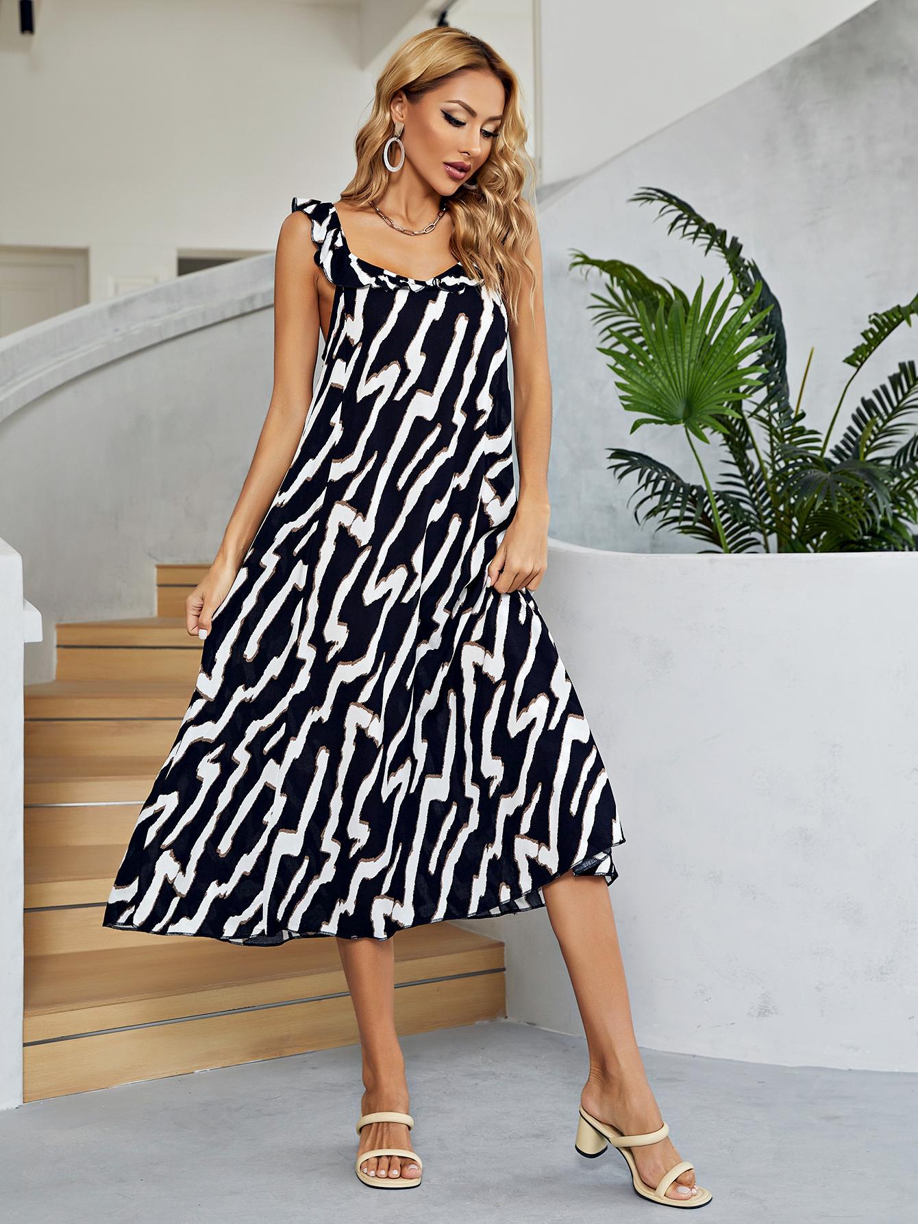 Graphic print tiered midi dress in black and white with ruffle straps and a square neckline.
