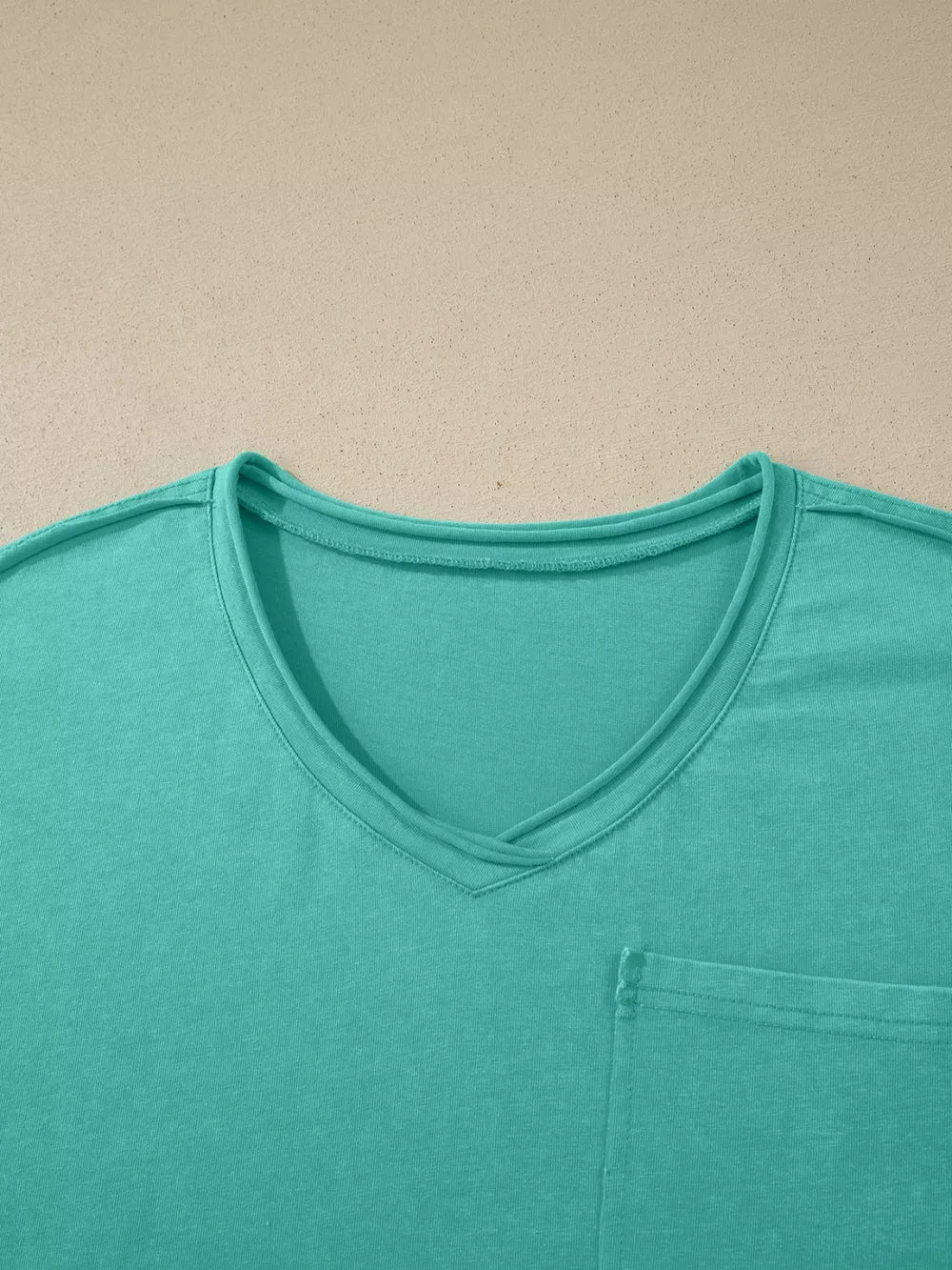 Teal mineral wash cotton v-neck tee with a chest pocket.