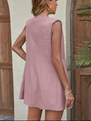 Pink sleeveless relaxed fit blazer with notched lapels and a textured fabric.