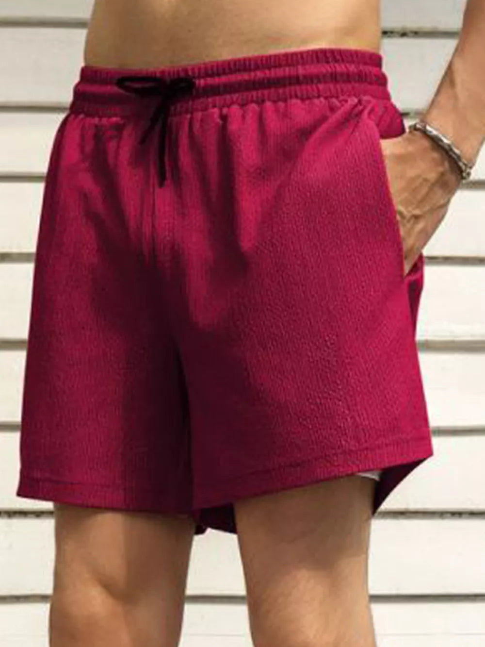 Burgundy chino shorts with drawstring waist and pockets.