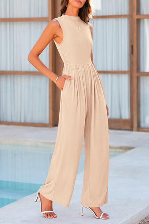 Tan ribbed mock neck sleeveless jumpsuit with wide legs and pleated waist detail.