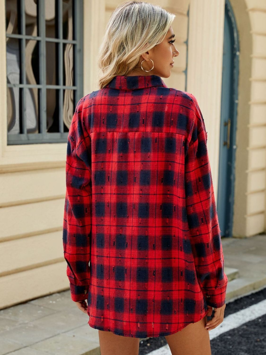 Distressed red and navy plaid overshirt with relaxed fit and buttoned cuffs.