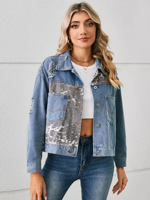 Denim trucker jacket with serpentine print, distressed details, and chest pockets.