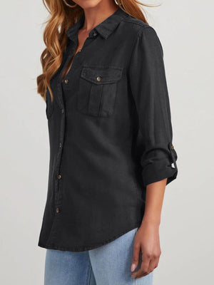 Black washed denim utility shirt with buttoned chest pockets and roll-tab sleeves.