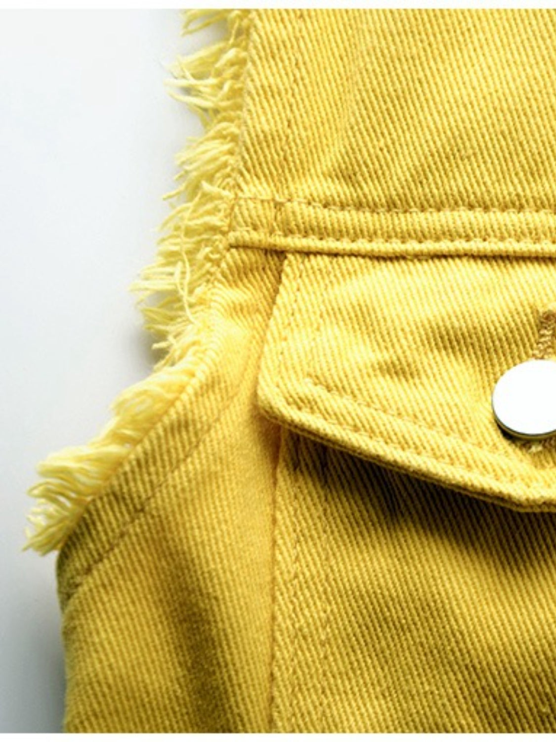 Yellow denim vest with frayed shoulders and a chest pocket detail.