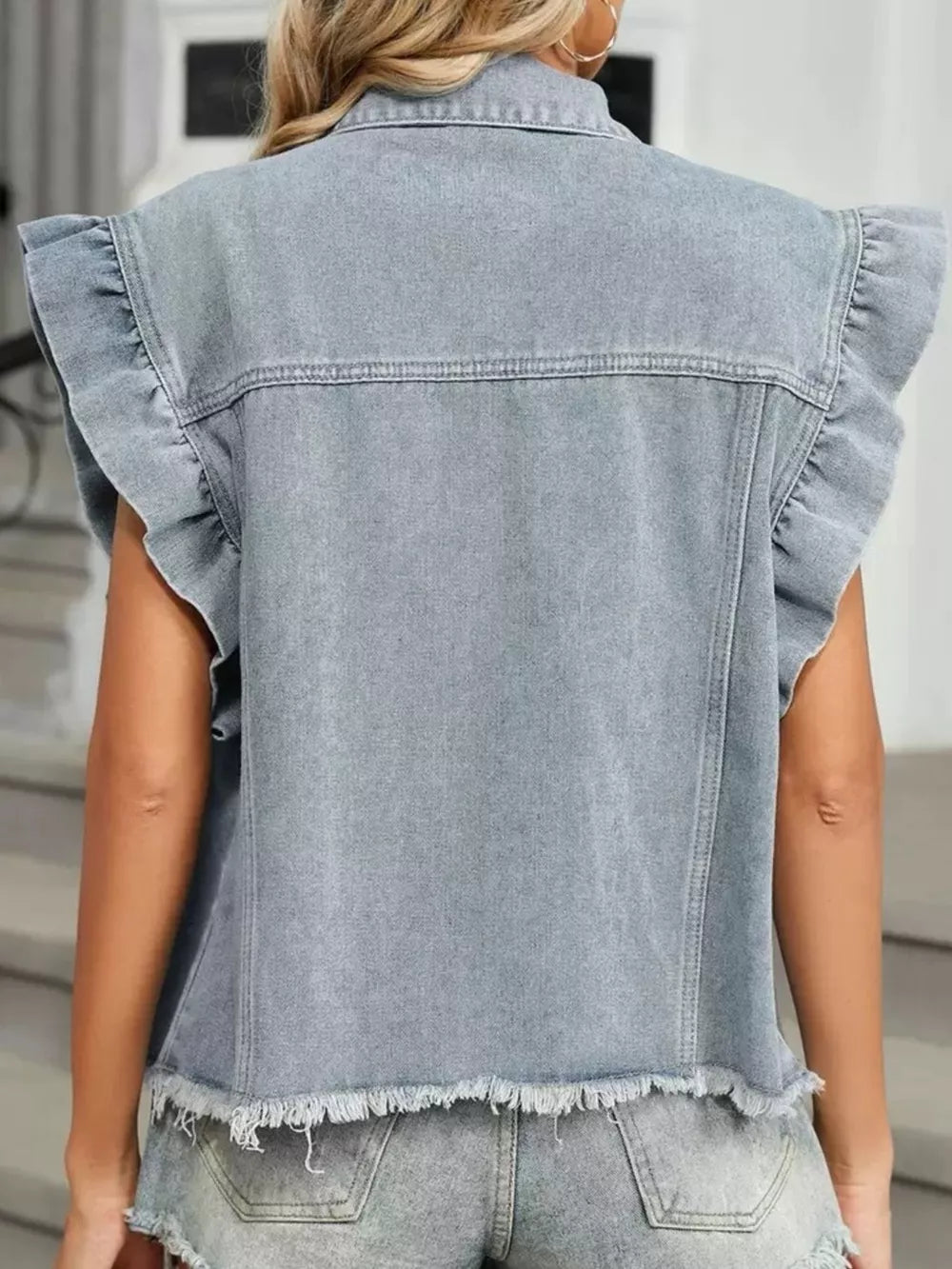 Denim vest with ruffled cap sleeves and frayed hem.
