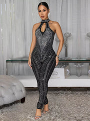 Black halter neck romper with rhinestone embellishments and keyhole cutout.