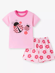 Pink baby girl's short sleeve top and shorts set with ladybug and flower graphics.