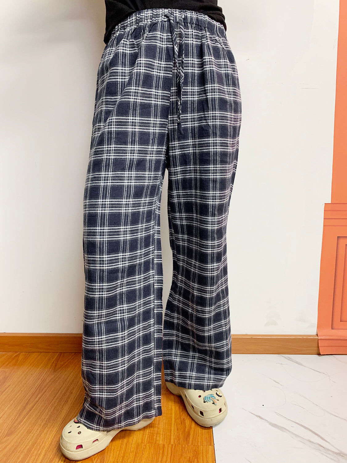 Relaxed plaid drawstring palazzo pants in dusty blue with a wide leg and front slit.