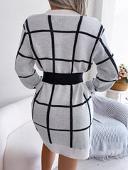 White geometric grid knit mini dress with black grid pattern and black elastic belt.