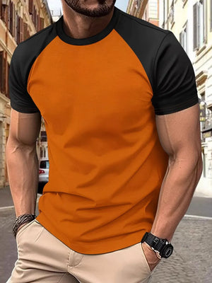 Colorblock raglan tee in orange with black sleeves and crew neck.