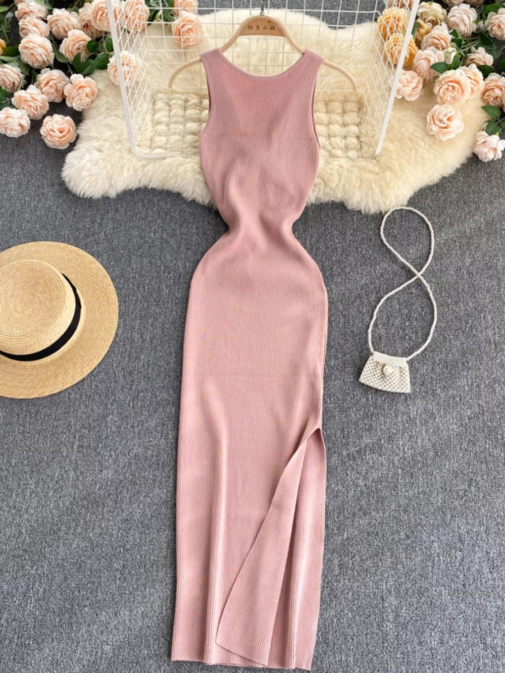 Pink ribbed knit bodycon midi dress with a high slit and cutout back detail.