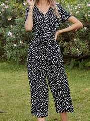 Black dotted print button-down jumpsuit with tie waist and v-neck