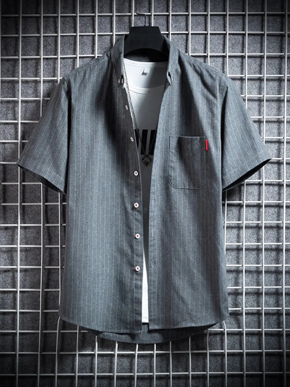 Grey pinstripe short sleeve button-up shirt with chest pocket, worn over a white tee.