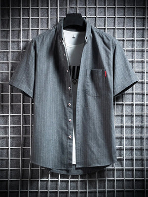 Grey pinstripe short sleeve button-up shirt with chest pocket, worn over a white tee.