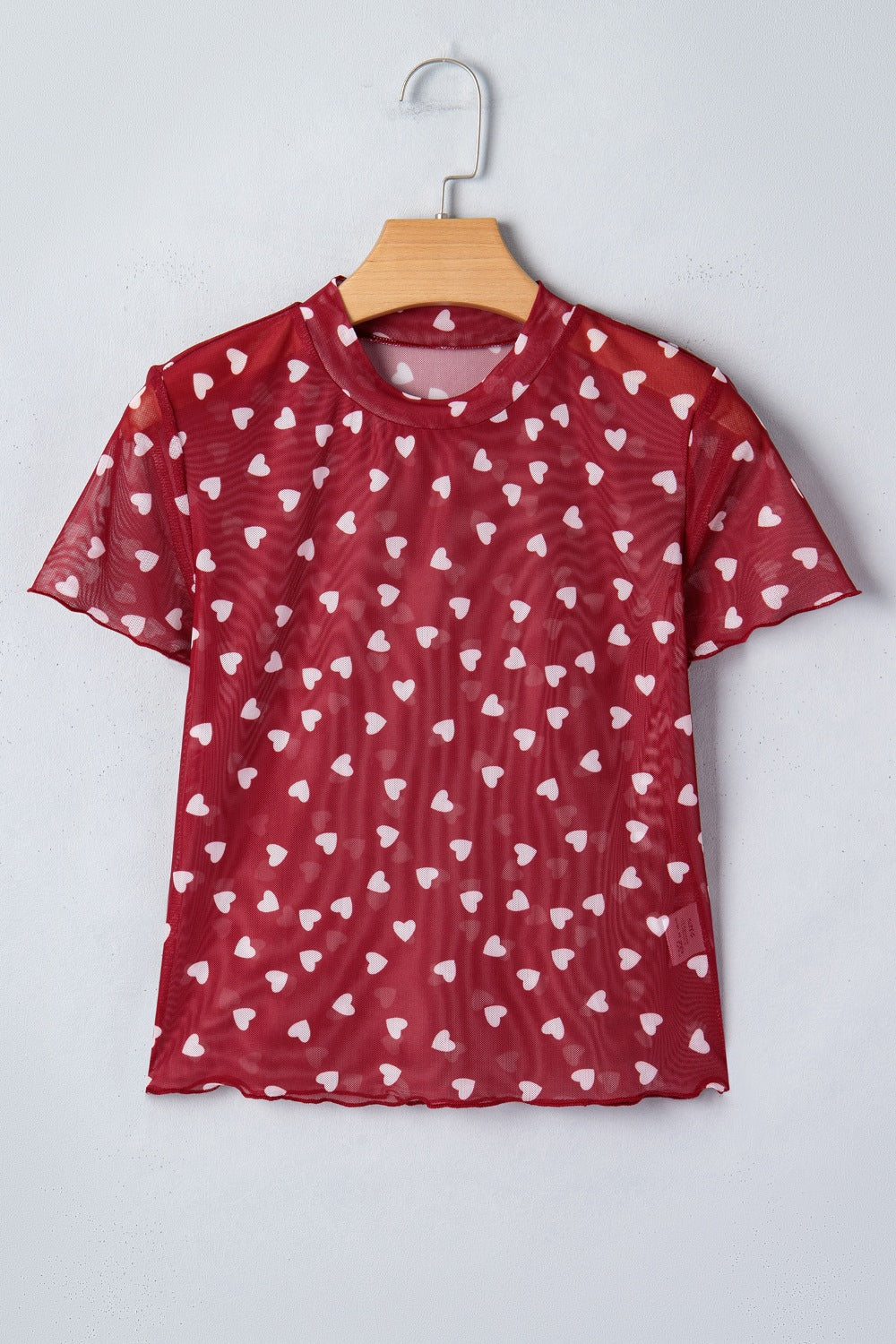 Deep Red sheer mesh t-shirt with all-over white heart print and short sleeves.