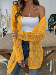 Openwork diamond knit duster cardigan in gold with long sleeves and open front, styled with a white cami.