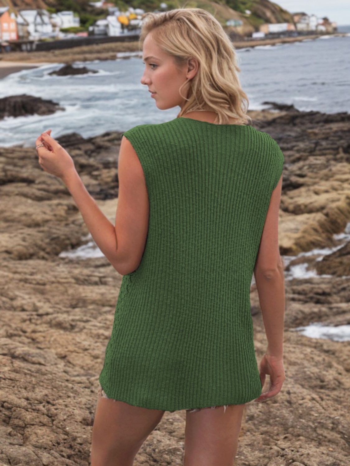 Dark green openwork button-down knit vest with a ribbed texture and sleeveless design.
