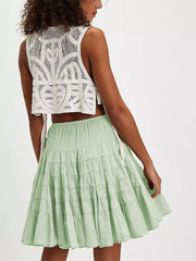 Tiered drawstring mini skirt in Sage green with ruffled tiers and a white crochet crop top.