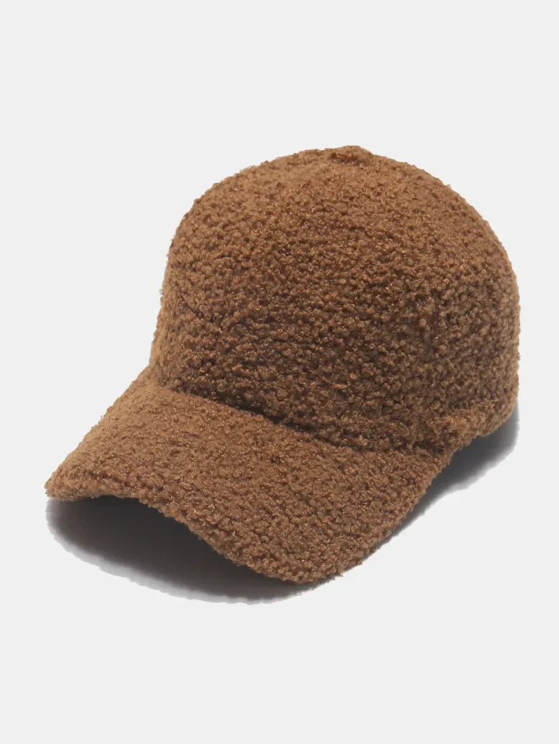 Brown sherpa baseball cap with textured material and curved brim.