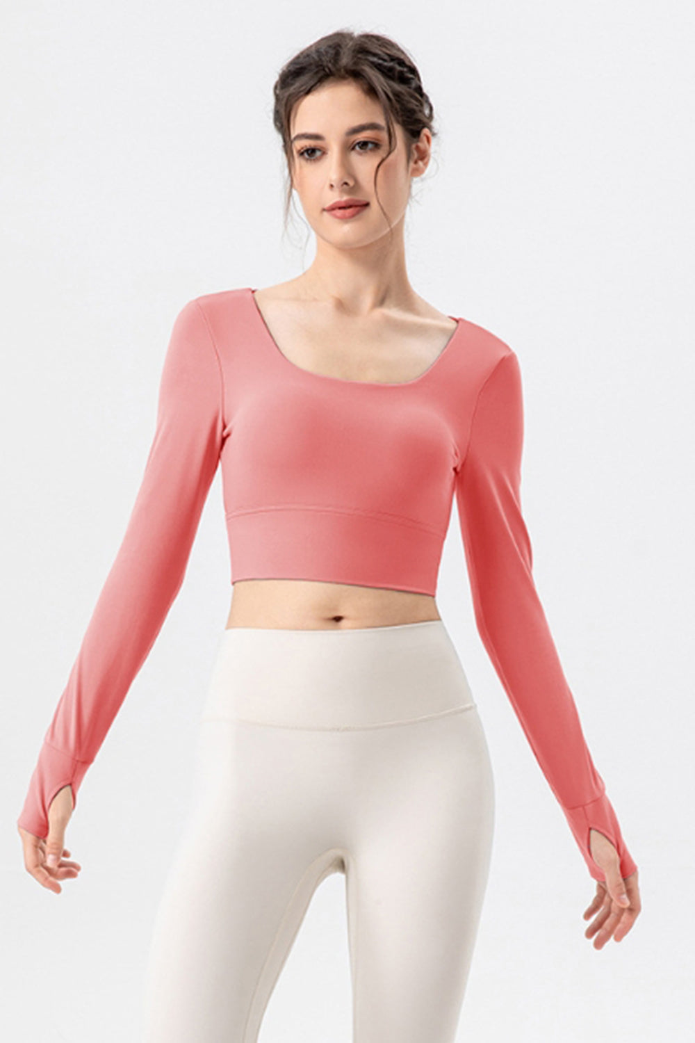 Coral pink long sleeve crop top with thumbholes and square neckline