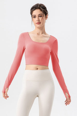 Coral pink long sleeve crop top with thumbholes and square neckline
