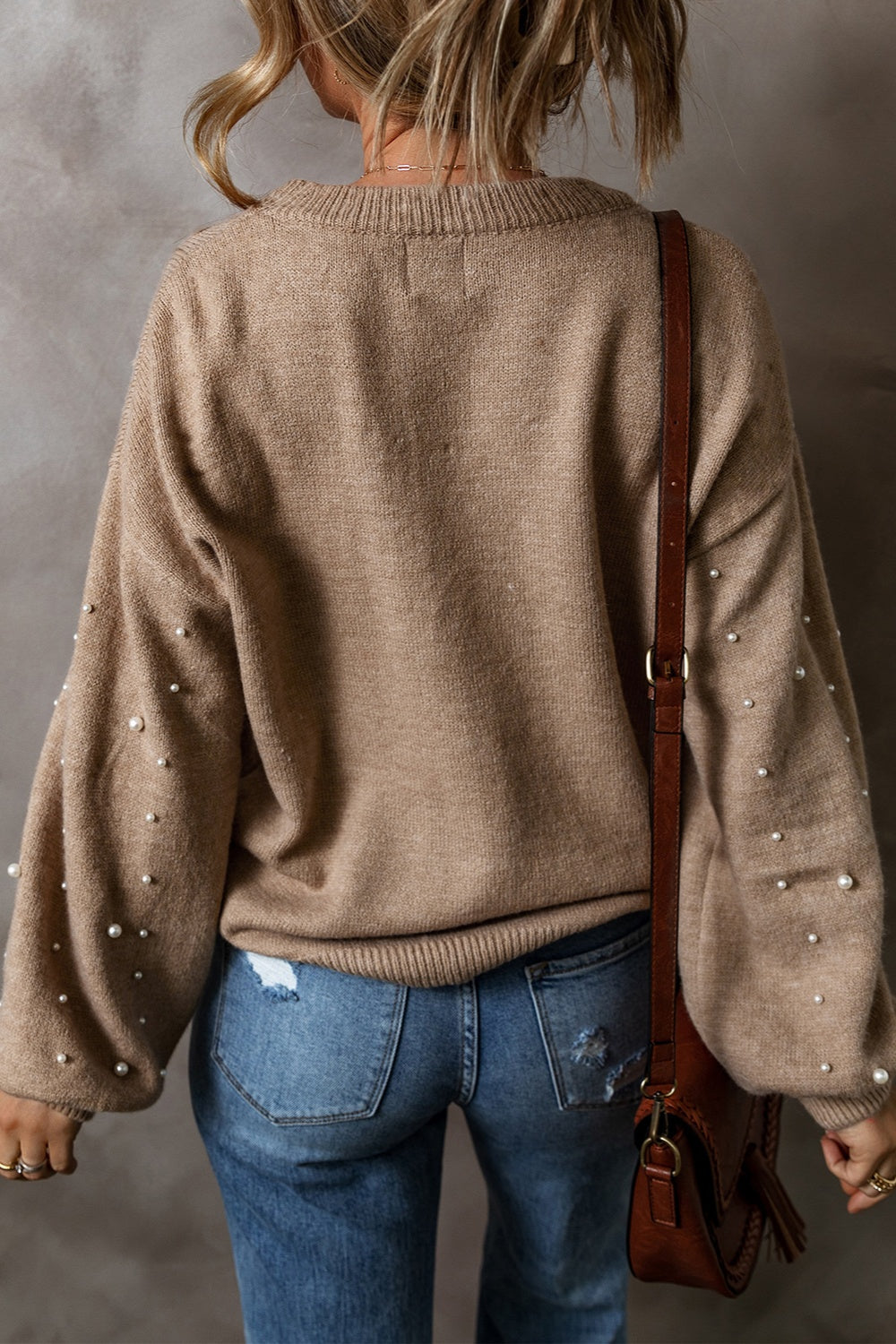 Mocha knit sweater with pearl-embellished sleeves and crew neck.