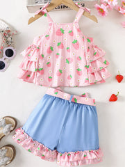 Strawberry print cami with tiered ruffles and bow straps paired with blue denim shorts with ruffled strawberry trim.