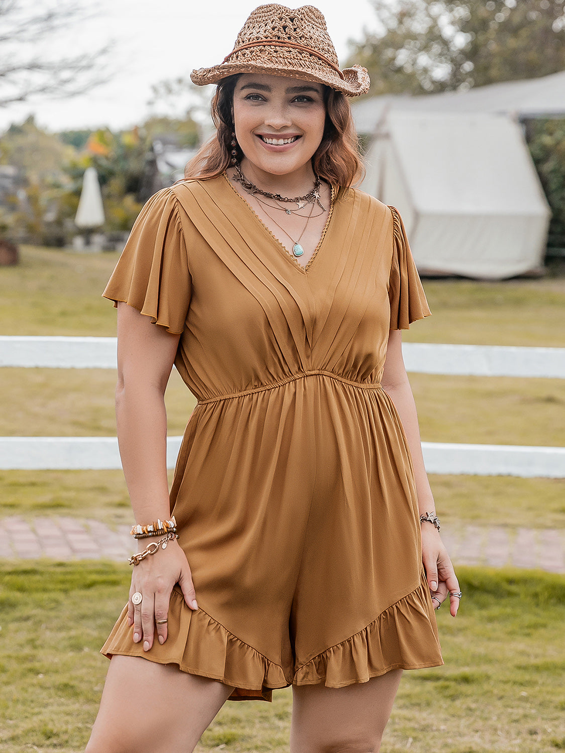 Caramel pleated bodice romper with flutter sleeves and ruffle hem shorts.