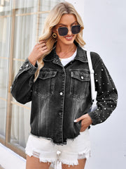 Black denim jacket with pearl embellishments and frayed hem.
