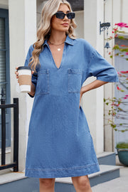 Collared denim mini dress in dark wash with V-neck, short sleeves, and two chest pockets.