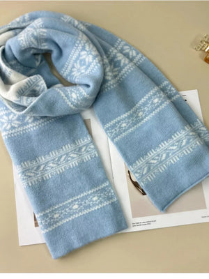 Sky blue wool blend scarf with white snowflake pattern and geometric bands.