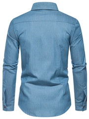 Light blue cotton denim shirt with button cuffs and functional pockets.