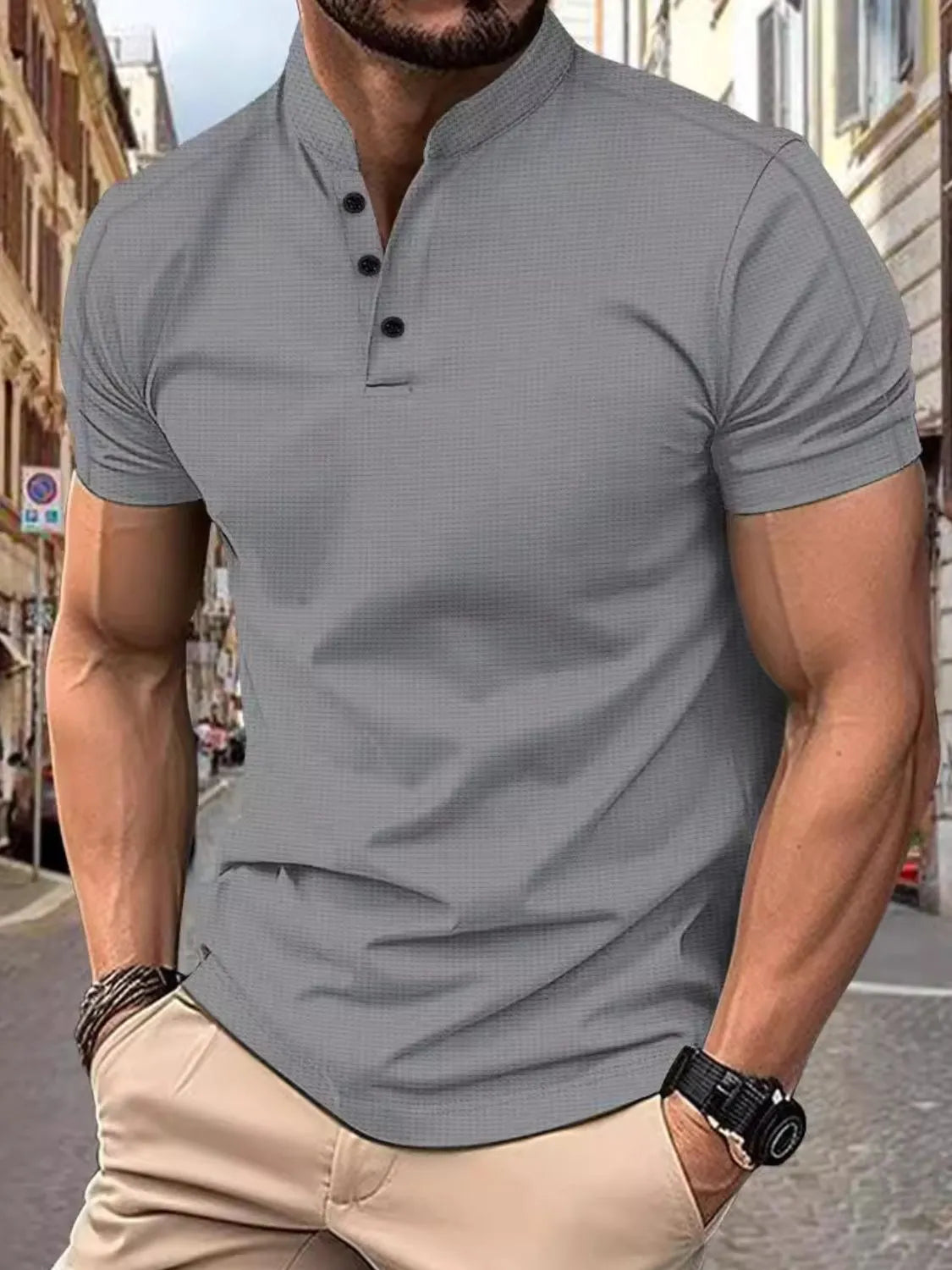 Men's gray short sleeve polo with buttoned neckline and textured fabric.