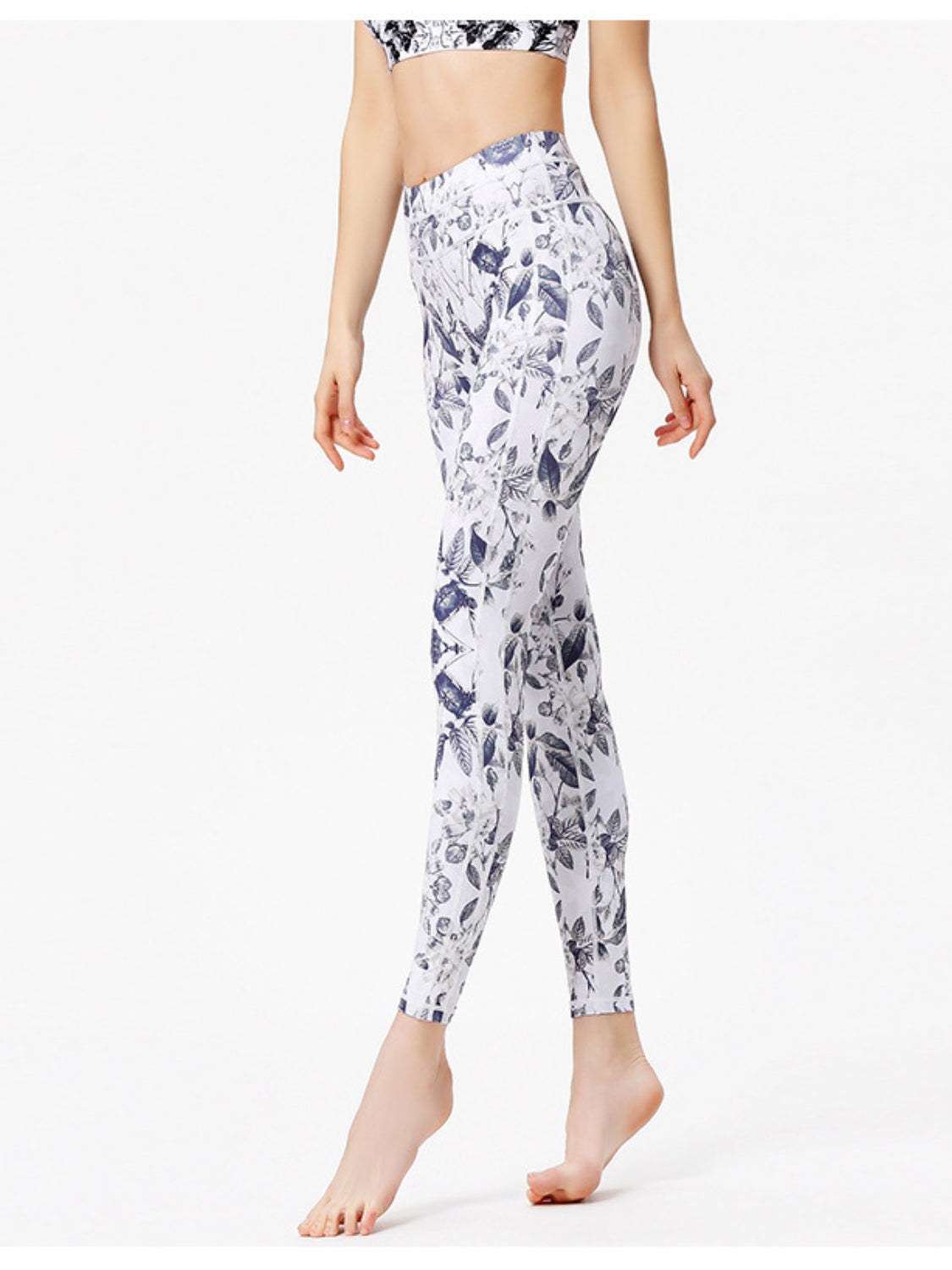 White leggings with a blue cosmic floral print and piping detail.