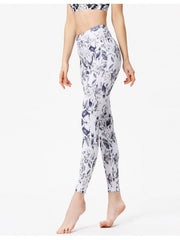 White leggings with a blue cosmic floral print and piping detail.